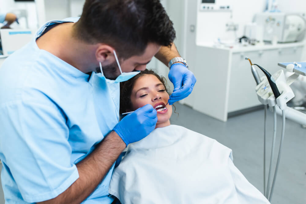 Young woman having dental treatment at dentist’s office